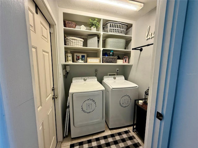 laundry room featuring light tile patterned floors and washer and dryer