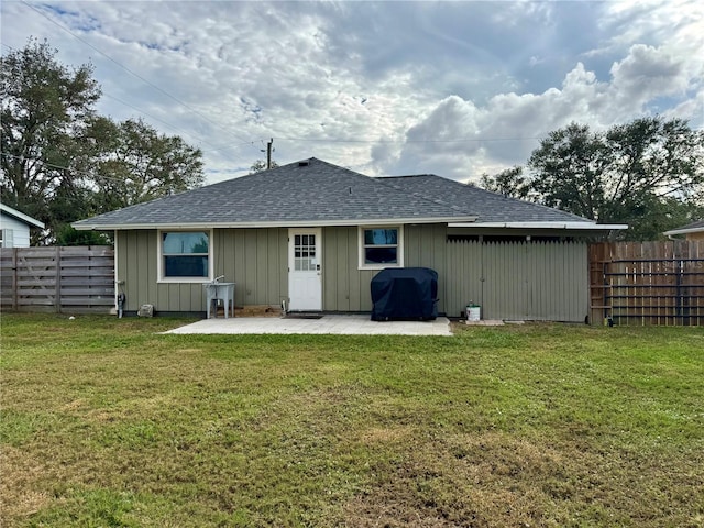 rear view of property with a patio area and a yard