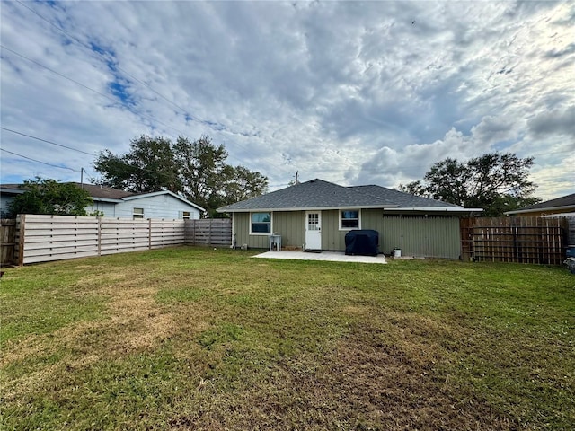 rear view of property with a lawn and a patio area