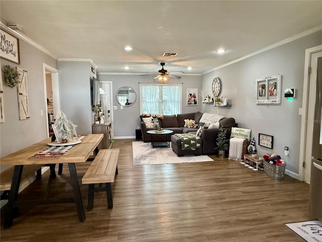 living room featuring hardwood / wood-style floors, ceiling fan, and crown molding