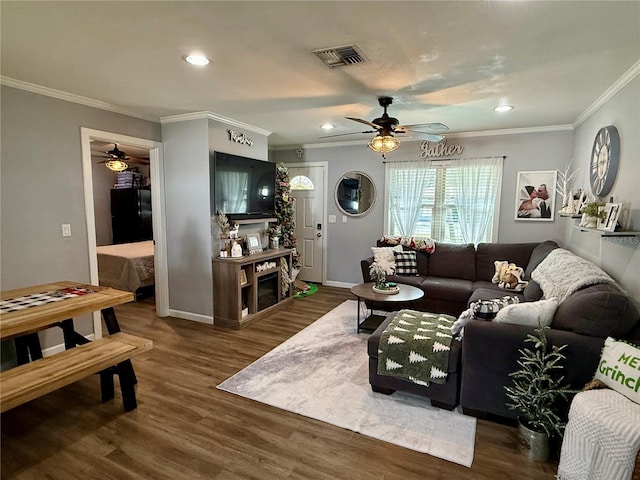 living room featuring ceiling fan, dark hardwood / wood-style flooring, and ornamental molding