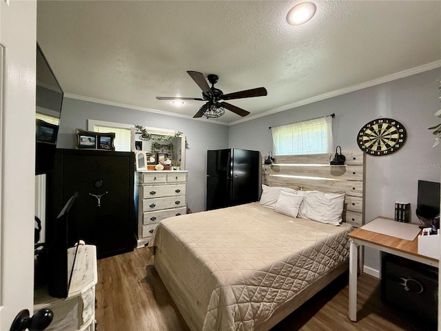 bedroom featuring hardwood / wood-style floors, ceiling fan, and ornamental molding