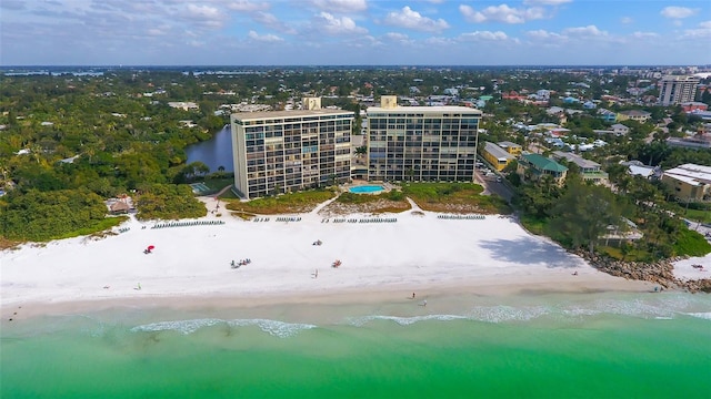 birds eye view of property featuring a water view and a beach view