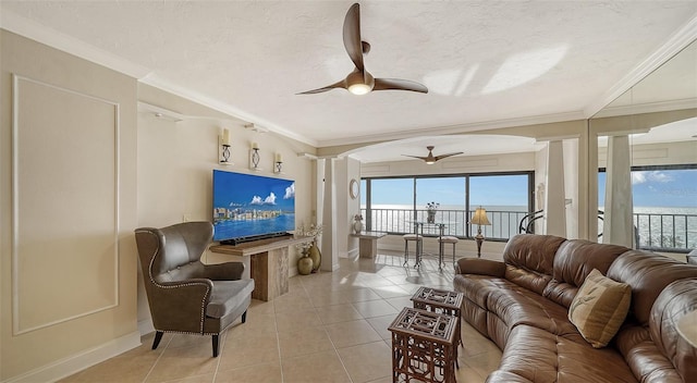 tiled living room featuring crown molding, a textured ceiling, and ceiling fan