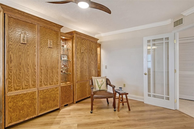 sitting room featuring crown molding, ceiling fan, and light hardwood / wood-style floors