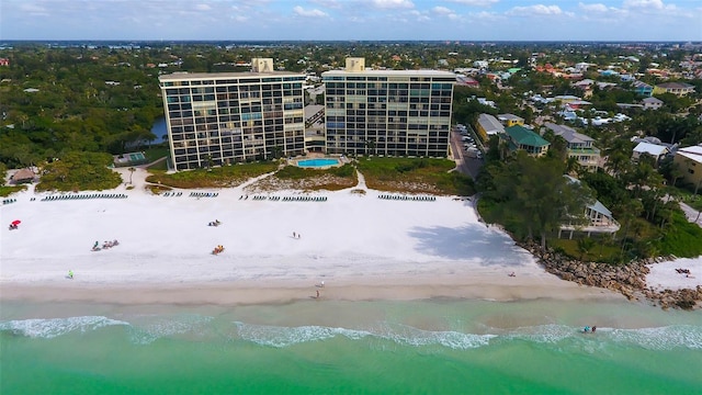 birds eye view of property with a view of the beach and a water view