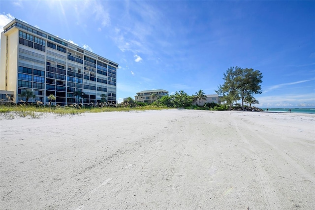 exterior space with a water view and a view of the beach