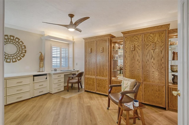 sitting room with crown molding, ceiling fan, and light wood-type flooring