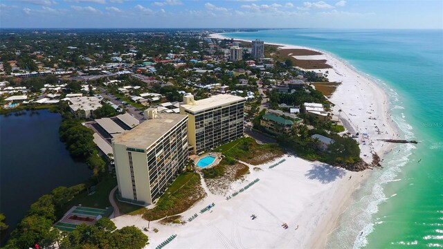 drone / aerial view with a water view and a beach view