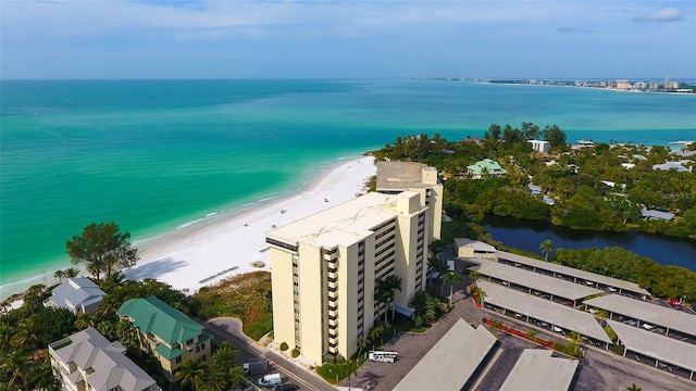 drone / aerial view featuring a water view and a beach view