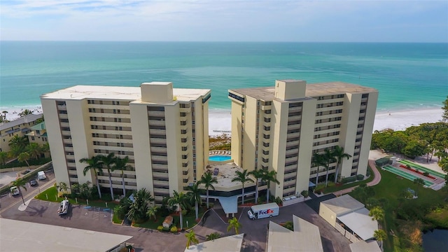 bird's eye view with a water view and a beach view