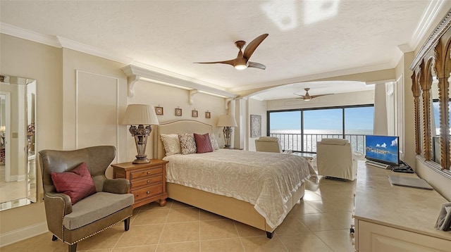 bedroom featuring access to exterior, crown molding, light tile patterned floors, and a textured ceiling