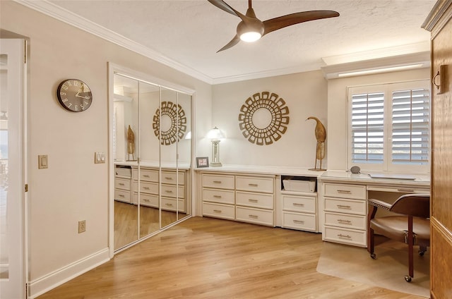 bathroom featuring a textured ceiling, wood-type flooring, ornamental molding, and ceiling fan