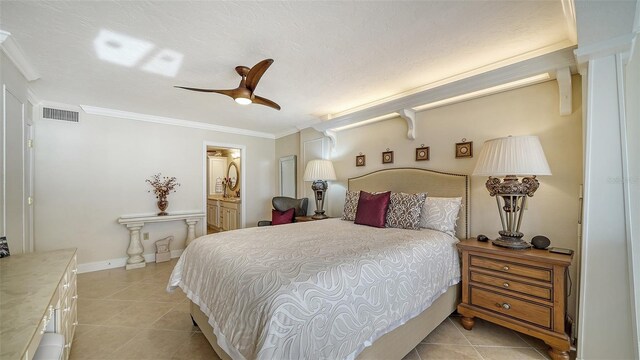 tiled bedroom with ceiling fan, ornamental molding, and ensuite bathroom