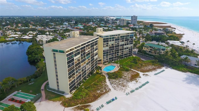 aerial view with a water view and a beach view