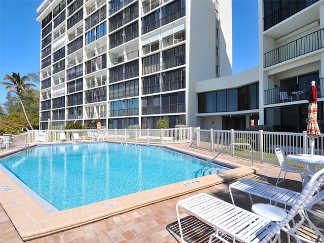 view of swimming pool featuring a patio area