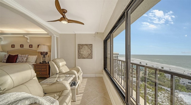 interior space featuring a water view, ceiling fan, and a beach view