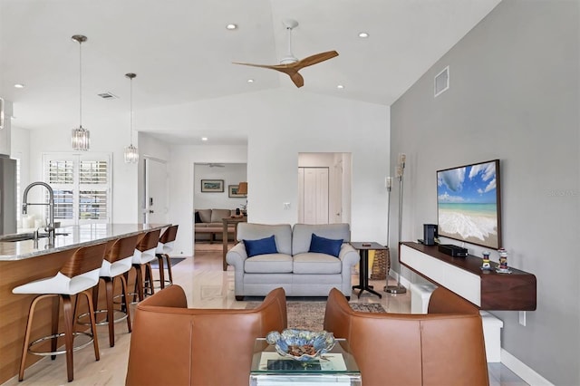 living room with ceiling fan, sink, and lofted ceiling