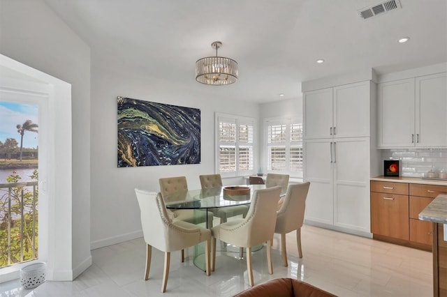 dining space featuring a chandelier and a healthy amount of sunlight