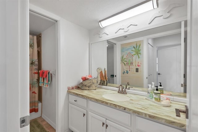 bathroom with vanity, a textured ceiling, and shower / tub combo