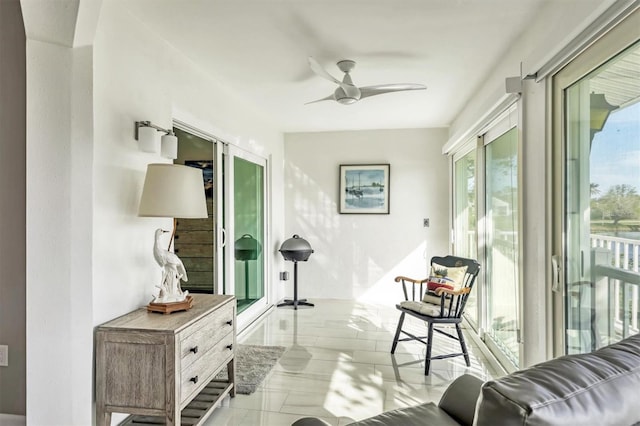 sunroom featuring ceiling fan