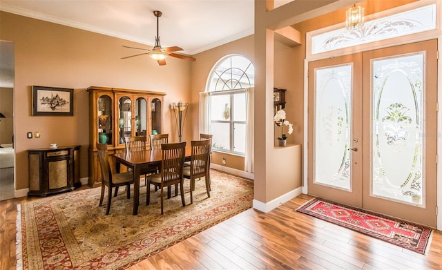 foyer with baseboards, french doors, wood-type flooring, and crown molding