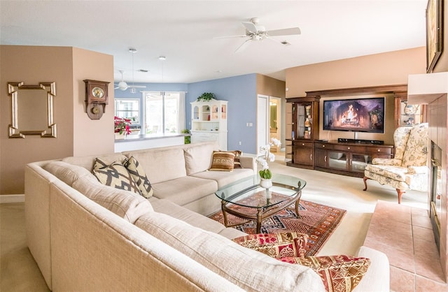 living room featuring carpet, ceiling fan, and baseboards