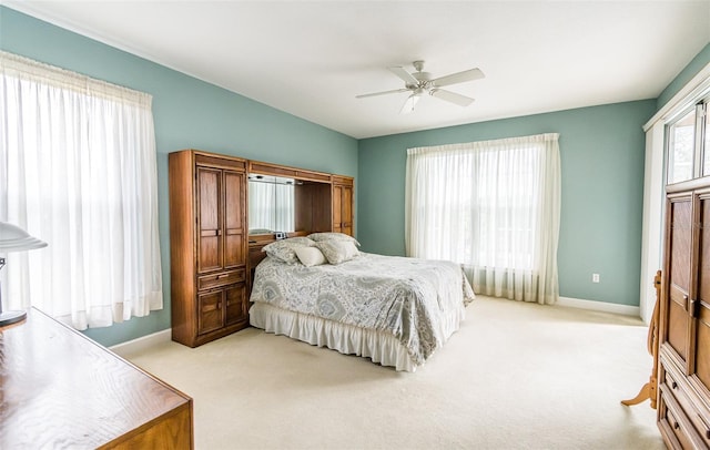 bedroom with carpet floors, ceiling fan, and baseboards