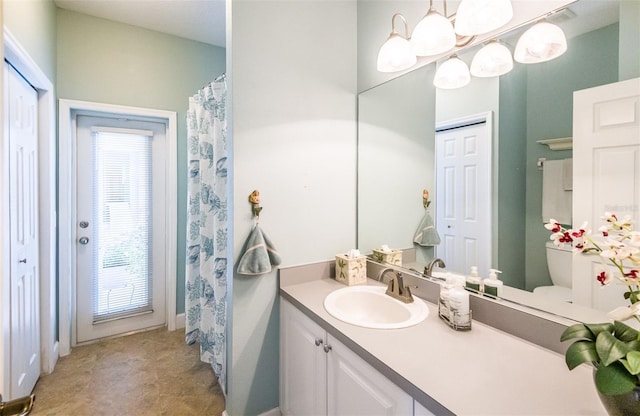 bathroom with toilet and vanity