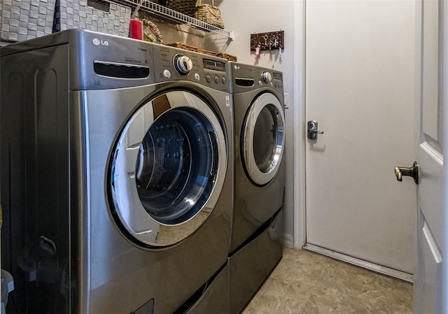 clothes washing area featuring laundry area and washing machine and dryer