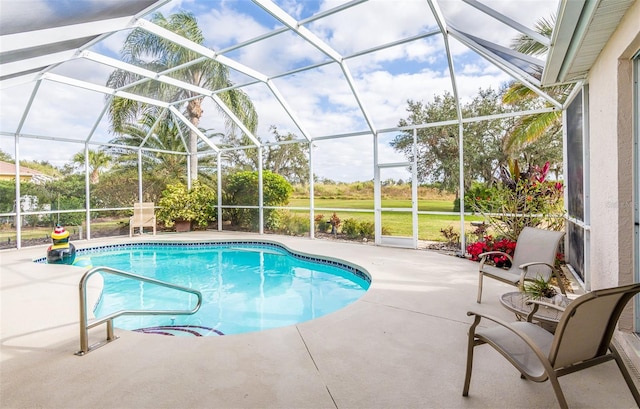 outdoor pool featuring a patio and glass enclosure