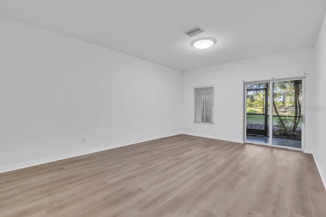 empty room with light hardwood / wood-style flooring