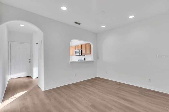 spare room featuring light hardwood / wood-style floors