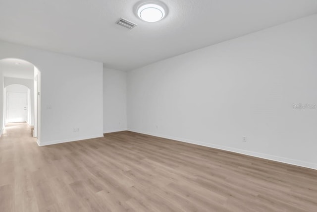 unfurnished room with light wood-type flooring