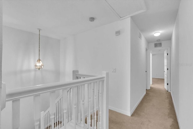 hallway featuring light colored carpet