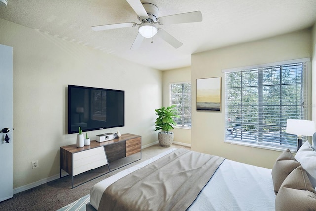 carpeted bedroom with a textured ceiling and ceiling fan