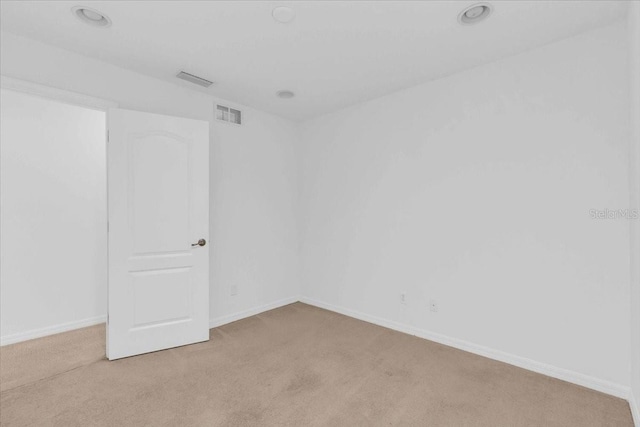 unfurnished room with light colored carpet