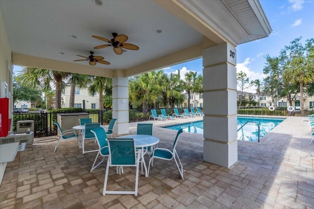 view of patio / terrace with ceiling fan and a community pool