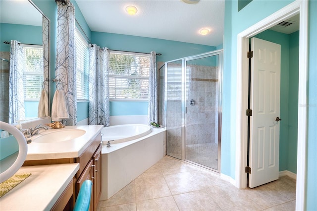 bathroom featuring tile patterned floors, vanity, separate shower and tub, and a wealth of natural light