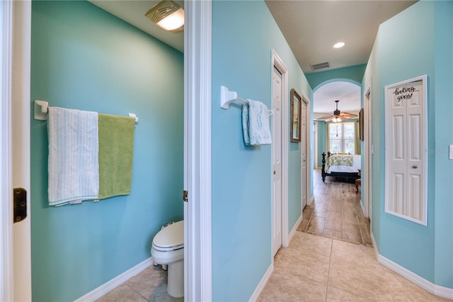 bathroom with tile patterned floors, ceiling fan, and toilet