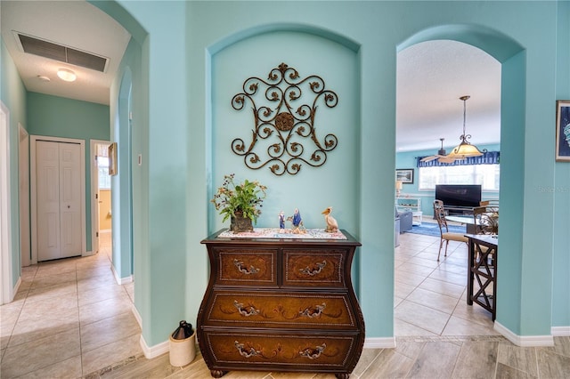 9351 Raes Creek Pl, Palmetto, FL 34221 - corridor featuring arched walkways and light tile patterned floors