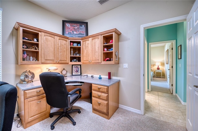 office area with light colored carpet and a textured ceiling