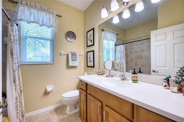 bathroom featuring tile patterned flooring, vanity, toilet, and a wealth of natural light