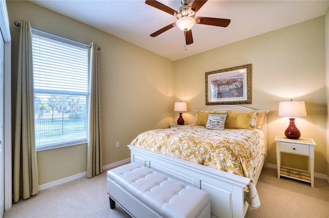 bedroom featuring ceiling fan and light carpet