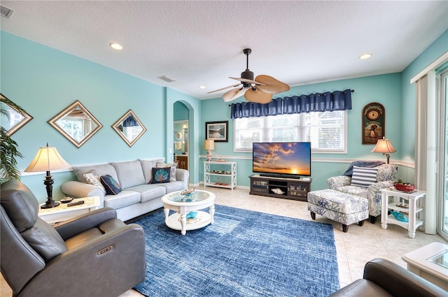 9351 Raes Creek Pl, Palmetto, FL 34221 - tiled living room featuring arched walkways, plenty of natural light, a ceiling fan, a textured ceiling, and recessed lighting