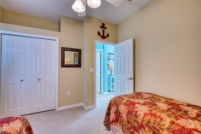 carpeted bedroom featuring a closet and ceiling fan