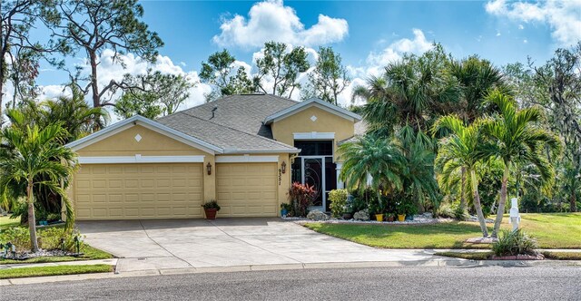 view of front of house with a front yard and a garage