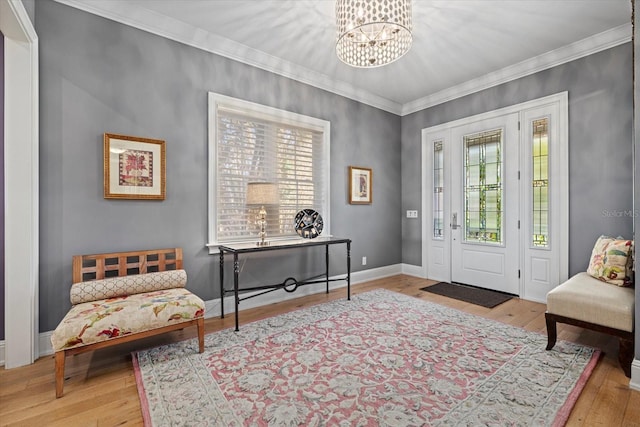 foyer entrance featuring hardwood / wood-style flooring, plenty of natural light, and a notable chandelier