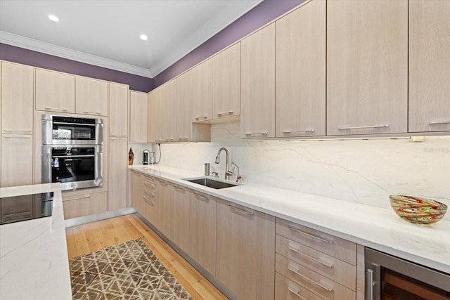 kitchen featuring light stone countertops, sink, beverage cooler, decorative backsplash, and light brown cabinetry