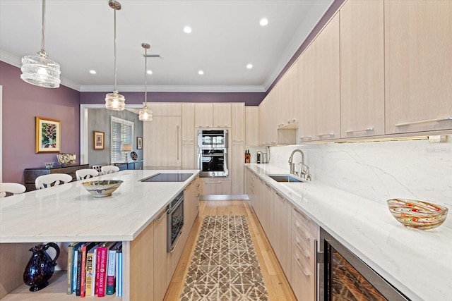 kitchen with sink, light stone counters, decorative backsplash, a breakfast bar, and a kitchen island